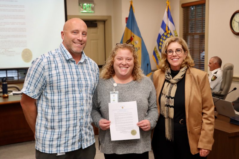 The Lewes Beach Patrol was named the city’s Extra Mile heroes for 2025. It received a proclamation in council chambers Oct. 13. Extra Mile Day is an annual recognition held across the country Nov. 1, honoring individuals and organizations that go the extra mile in service and positive action. Shown are (l-r) Strohm Edwards, Lewes Beach Patrol captain; Giulia Kirsch, parks and marina administrator; and Amy Marasco, Lewes mayor.